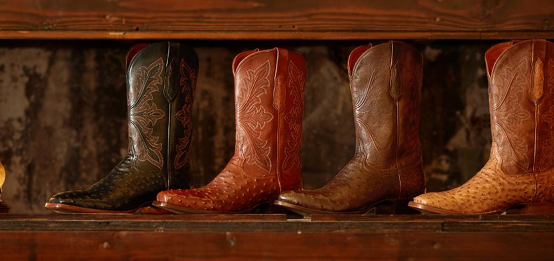 Ariat Western bench made boots lined up on a window sill